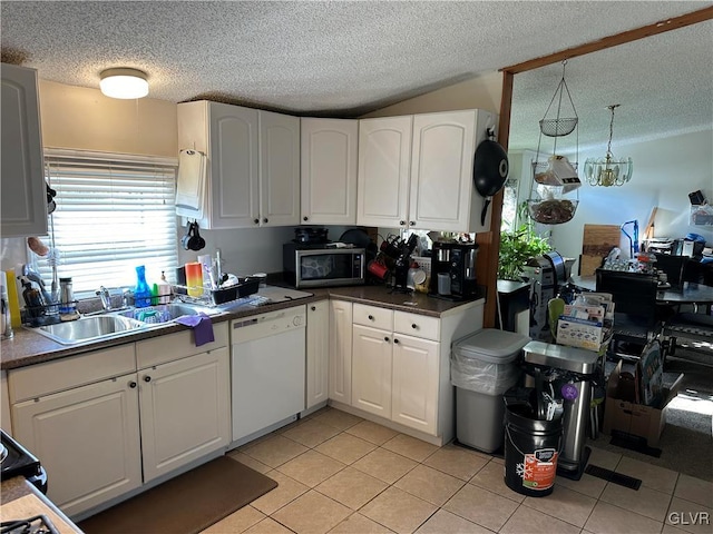 kitchen with white cabinetry, dishwasher, a textured ceiling, and light tile patterned floors