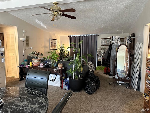 living room featuring vaulted ceiling, ceiling fan, a textured ceiling, and dark carpet