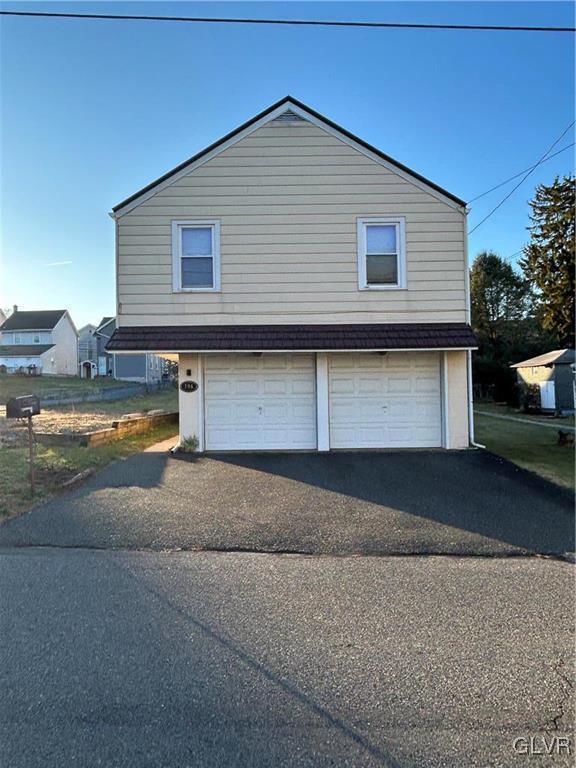 view of side of home with a garage