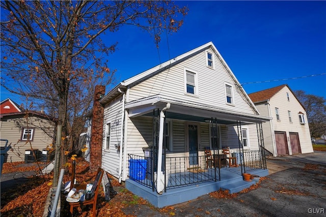 view of front of home with a porch and a garage