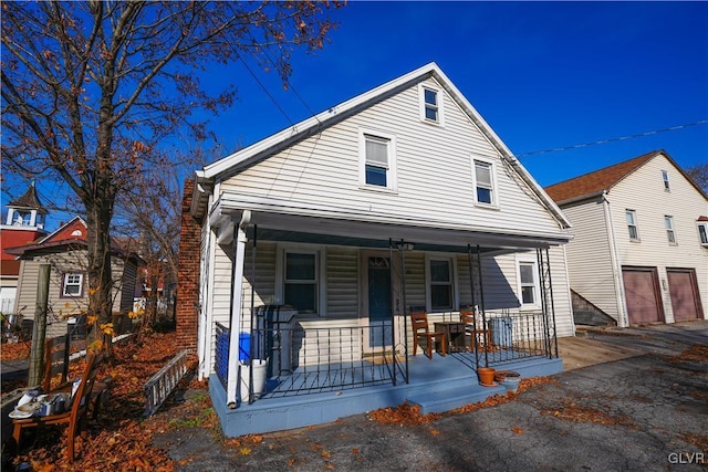 bungalow-style house featuring a garage and a porch