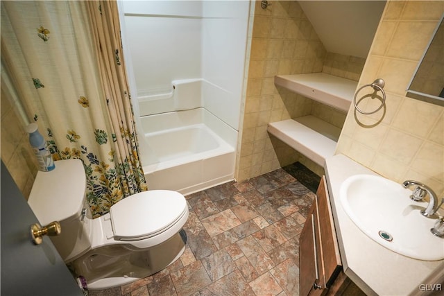 full bathroom with tile walls, shower / tub combo, vanity, and toilet