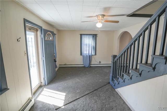 carpeted entrance foyer featuring ceiling fan, a baseboard radiator, and a healthy amount of sunlight