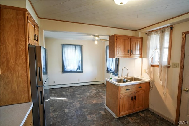 kitchen featuring sink, stainless steel fridge, ceiling fan, ornamental molding, and a baseboard radiator