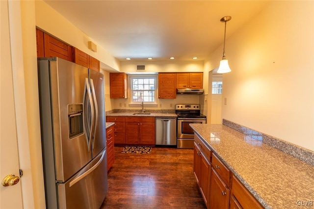 kitchen featuring dark wood-type flooring, stainless steel appliances, decorative light fixtures, and sink