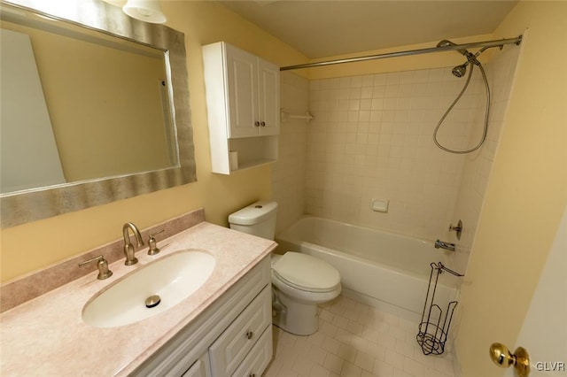 full bathroom featuring tiled shower / bath, vanity, toilet, and tile patterned floors