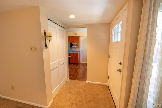 hall featuring light colored carpet