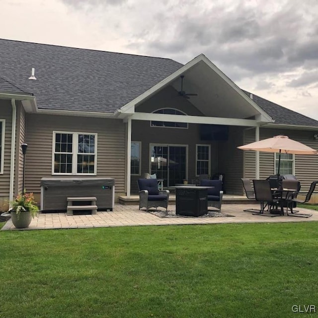 back of house with a yard, a patio area, a hot tub, and ceiling fan