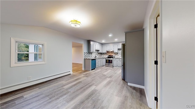 kitchen with gray cabinets, vaulted ceiling, appliances with stainless steel finishes, tasteful backsplash, and a baseboard heating unit