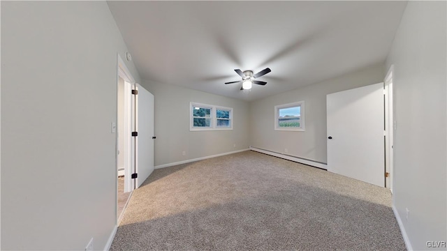 empty room with a baseboard heating unit, light colored carpet, and ceiling fan