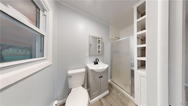 bathroom featuring toilet, vanity, and walk in shower