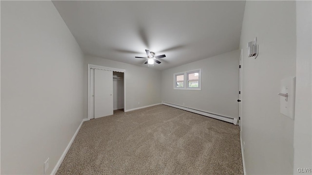 unfurnished bedroom featuring a baseboard radiator, light colored carpet, ceiling fan, and a closet