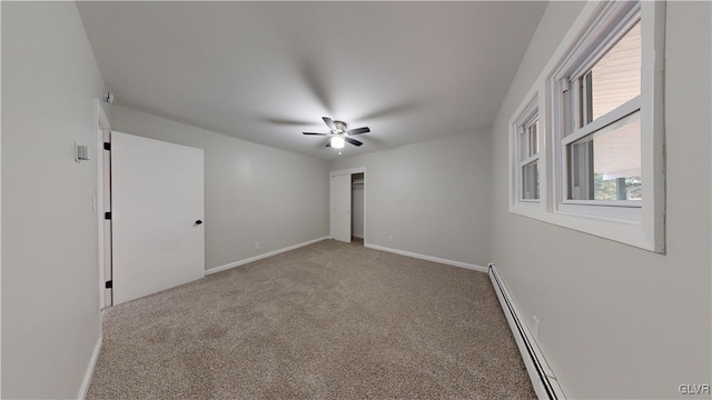 empty room with ceiling fan, a baseboard radiator, and carpet floors