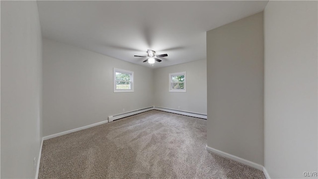 spare room with carpet, ceiling fan, and baseboard heating