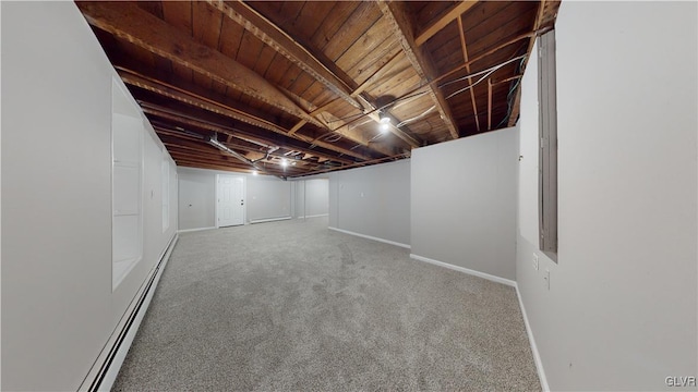 basement featuring a baseboard radiator and carpet floors