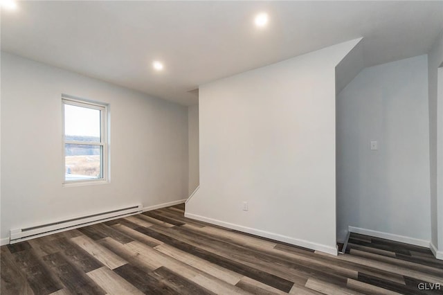 spare room featuring dark hardwood / wood-style flooring and baseboard heating