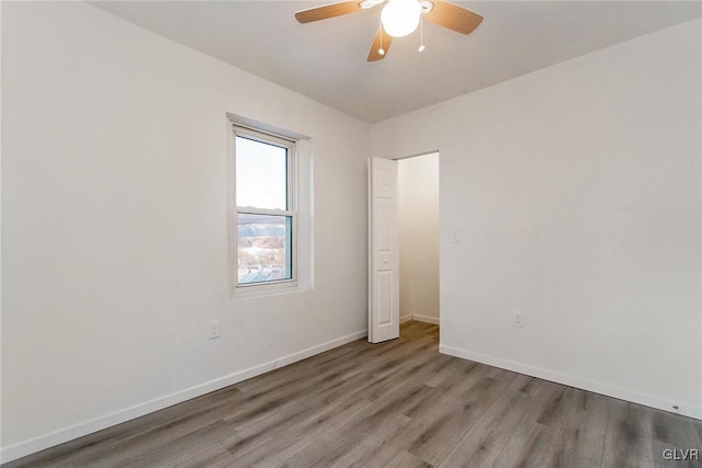 empty room with ceiling fan and light hardwood / wood-style floors