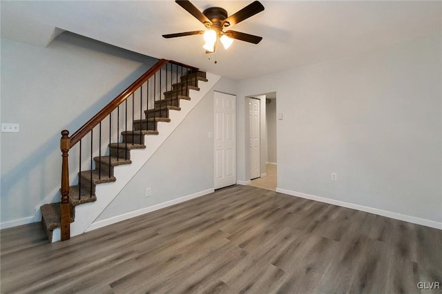 interior space with dark wood-type flooring and ceiling fan