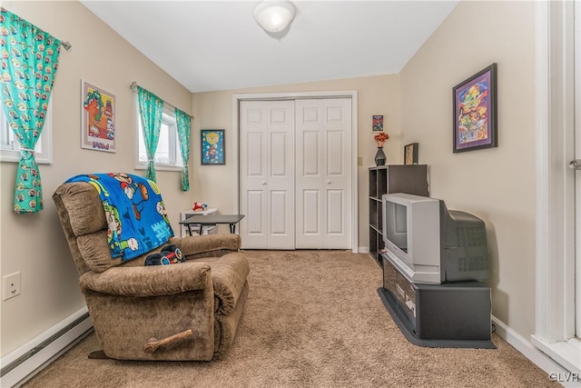 sitting room featuring a baseboard radiator, lofted ceiling, and carpet flooring