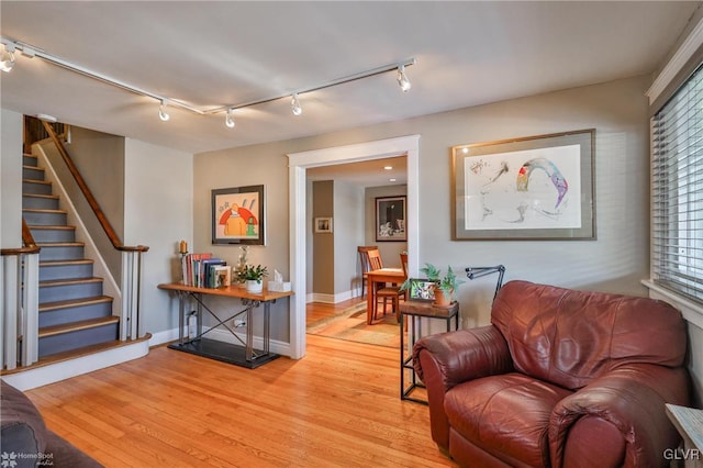 sitting room with rail lighting and light hardwood / wood-style floors