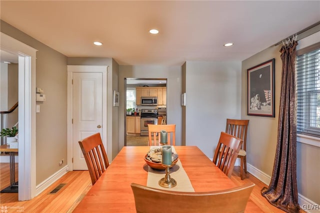 dining space with light hardwood / wood-style flooring