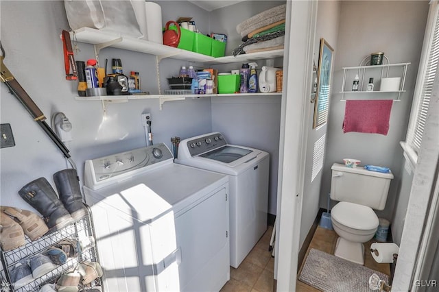 laundry room featuring light tile patterned flooring and washing machine and dryer