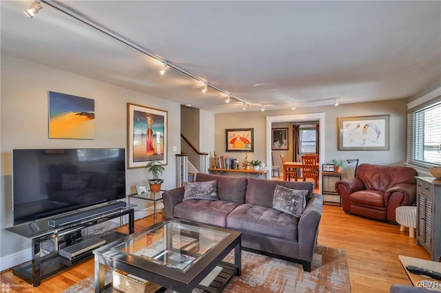 living room featuring baseboard heating and light wood-type flooring