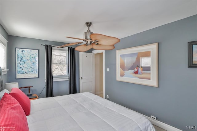 bedroom featuring multiple windows and ceiling fan