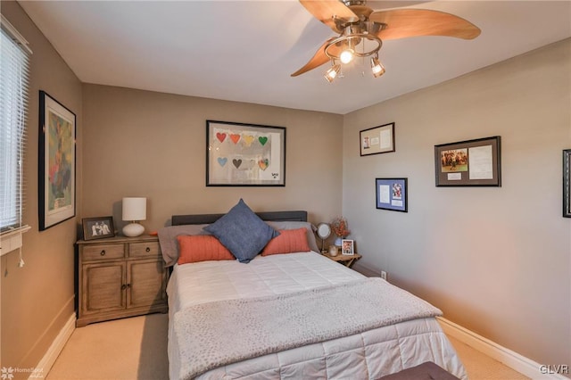 bedroom featuring ceiling fan and light carpet