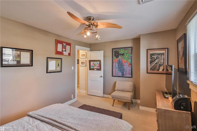 bedroom with light carpet and ceiling fan