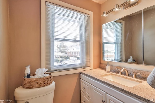 bathroom featuring vanity and toilet