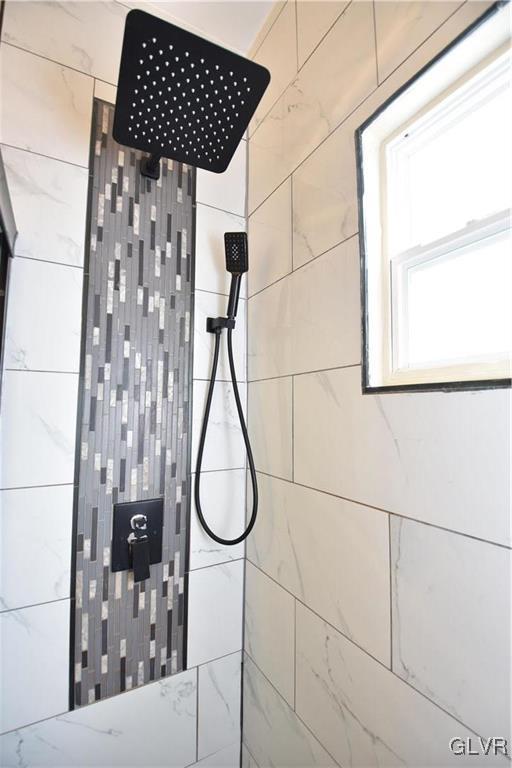 bathroom with a tile shower