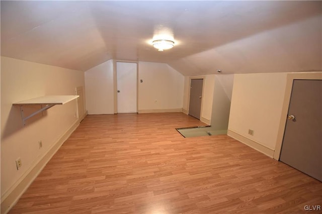 bonus room with light hardwood / wood-style flooring and vaulted ceiling