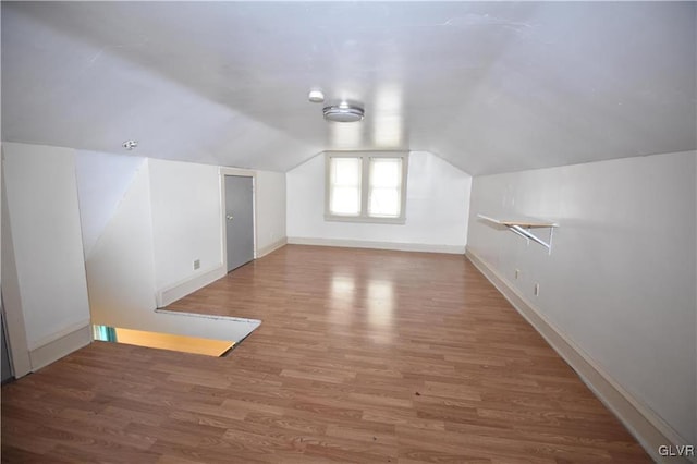 bonus room with lofted ceiling and wood-type flooring