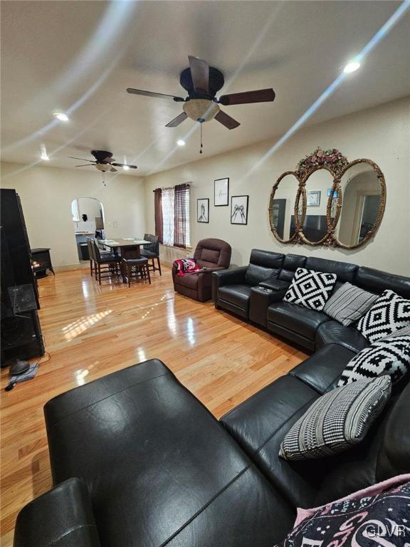 living room featuring hardwood / wood-style flooring and ceiling fan