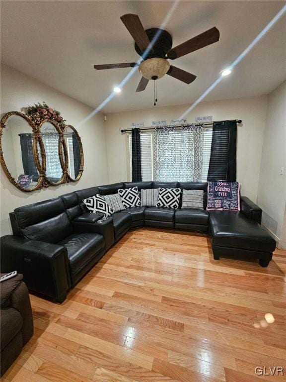 living room featuring ceiling fan and light wood-type flooring