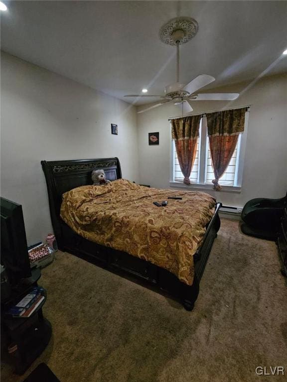 carpeted bedroom featuring a baseboard radiator and ceiling fan