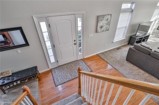 foyer with hardwood / wood-style flooring and a wealth of natural light