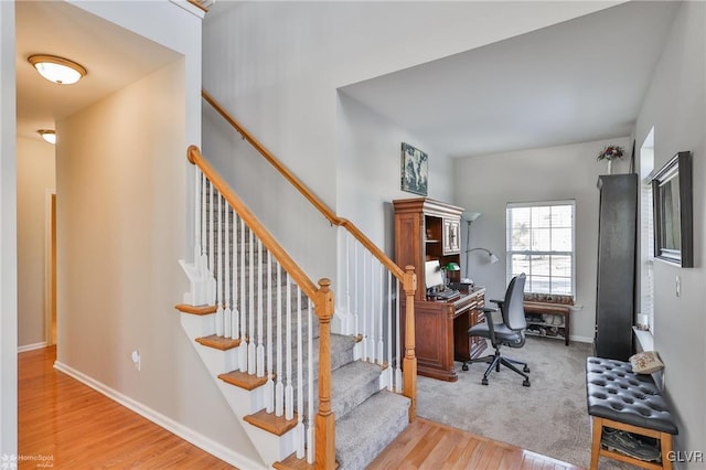 stairs with hardwood / wood-style floors