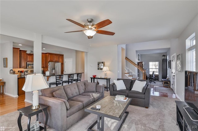 living room with ceiling fan and light carpet