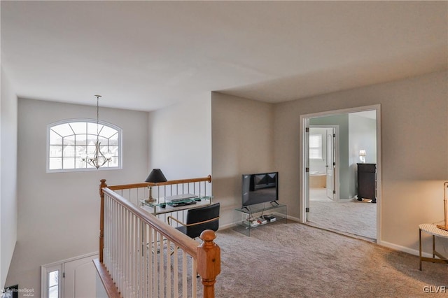 interior space featuring a chandelier and carpet floors