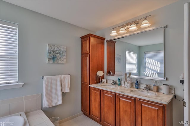 bathroom featuring vanity, tile patterned flooring, and a tub