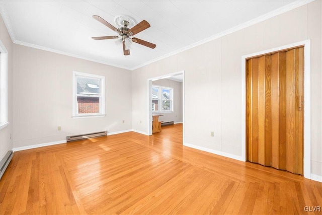 empty room featuring a baseboard heating unit, wood-type flooring, ornamental molding, and ceiling fan