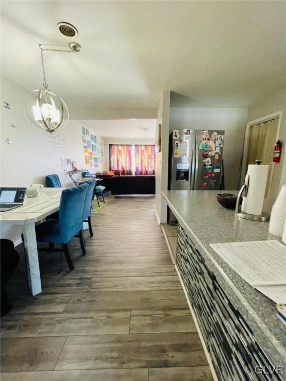 dining area featuring a chandelier and hardwood / wood-style floors