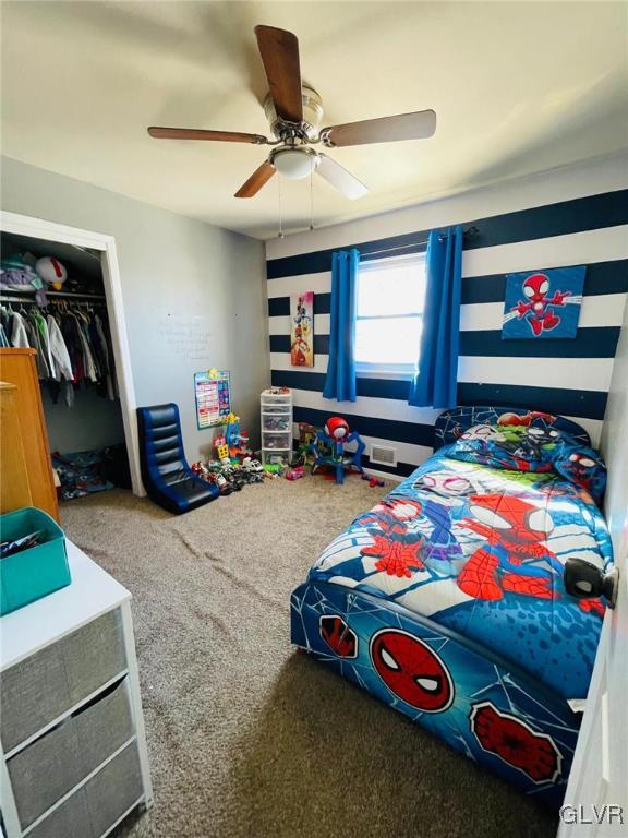 bedroom with carpet floors, a closet, and ceiling fan