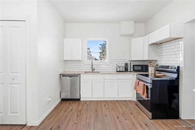 kitchen featuring white cabinetry, appliances with stainless steel finishes, and tasteful backsplash