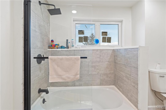 bathroom featuring tiled shower / bath and toilet