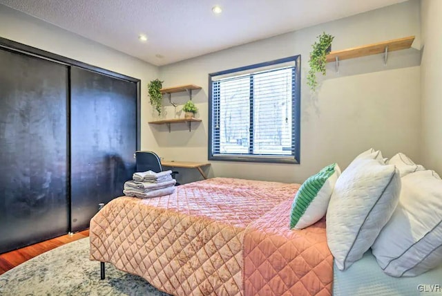 bedroom with hardwood / wood-style floors and a closet