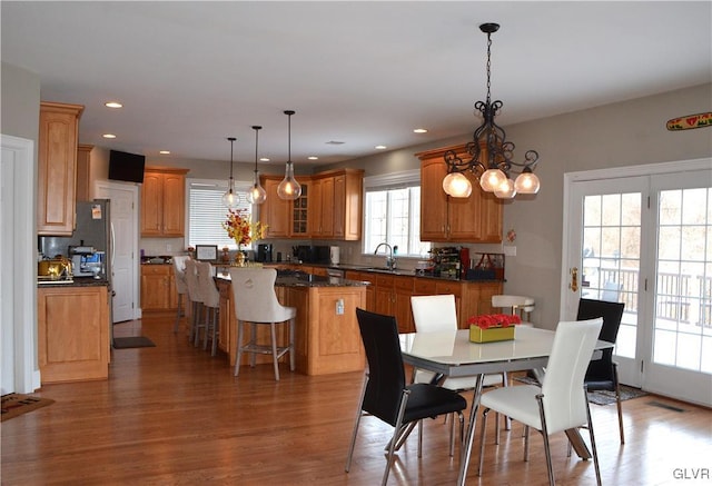 dining area with dark hardwood / wood-style floors and sink