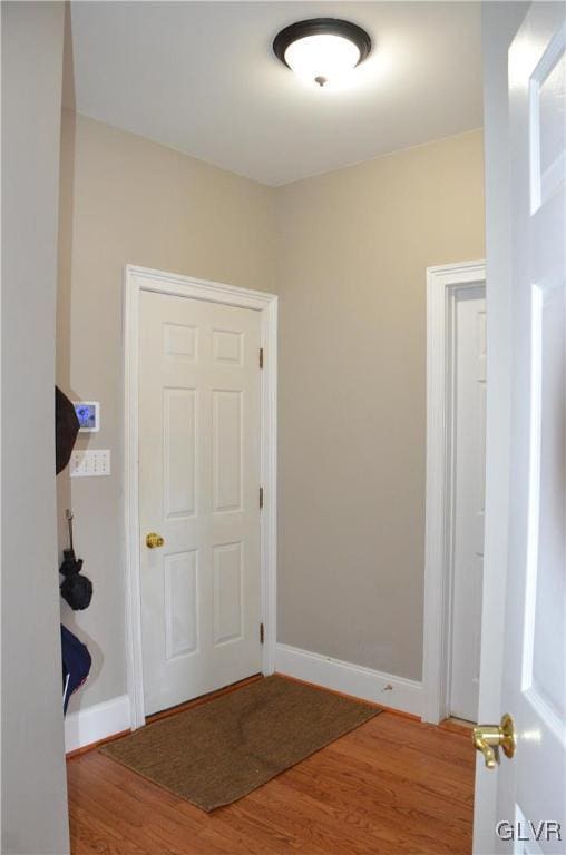 corridor featuring hardwood / wood-style floors